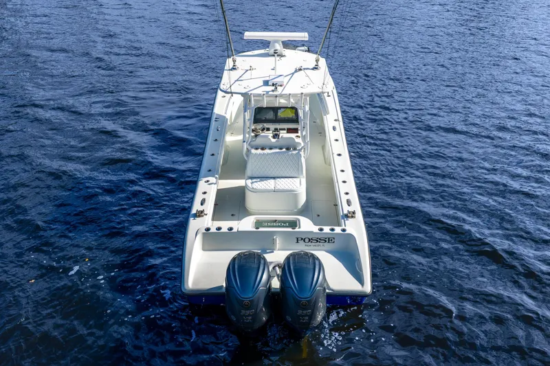 Slide: The Image of 2014 Yellowfin 32 Offshore boat on water, rear view with dual engines. - 8