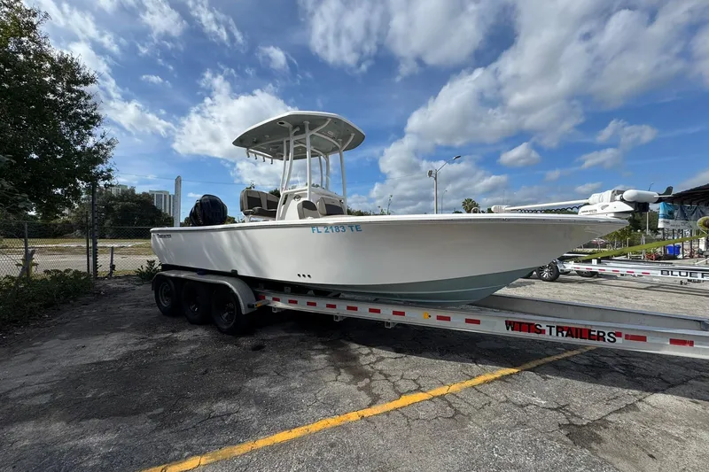 Slide: The Image of 2022 Tidewater 2300 Carolina Bay boat on trailer under blue sky. - 1