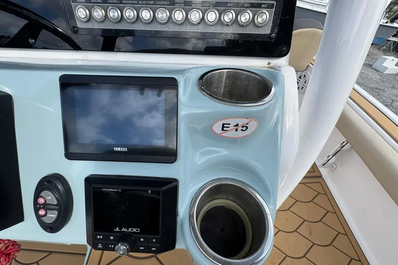 Slide: The Image of 2022 Tidewater 2300 Carolina Bay dashboard with Yamaha display and JL Audio system. - 13