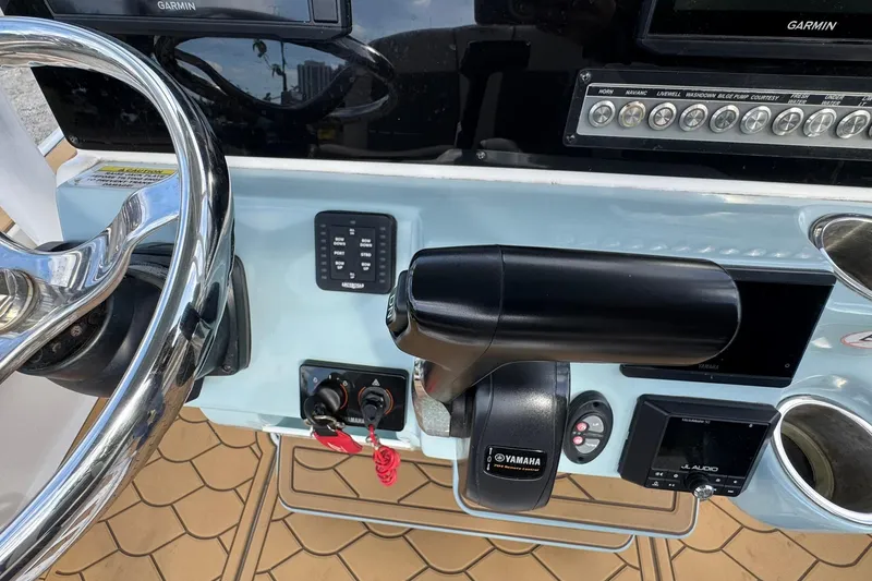 Slide: The Image of Control panel of 2022 Tidewater 2300 Carolina Bay boat with Yamaha throttle and Garmin display. - 14