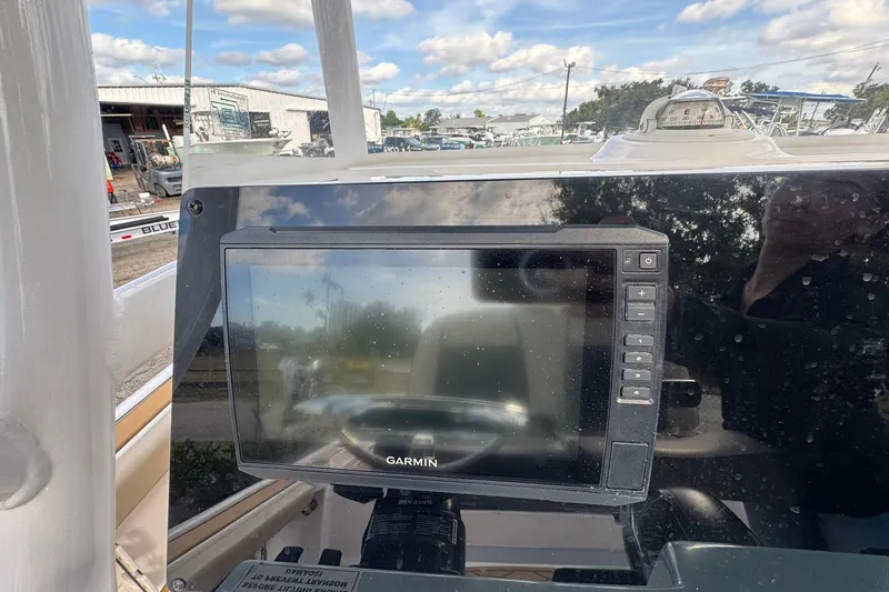 Slide: The Image of Garmin display on 2022 Tidewater 2300 Carolina Bay boat dashboard, outdoor setting. - 16