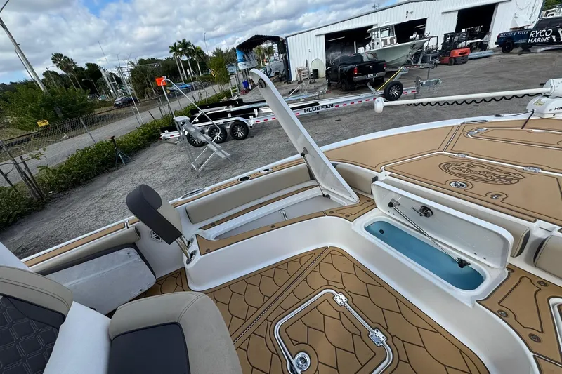 Slide: The Image of 2022 Tidewater 2300 Carolina Bay boat interior with open storage compartments. - 23
