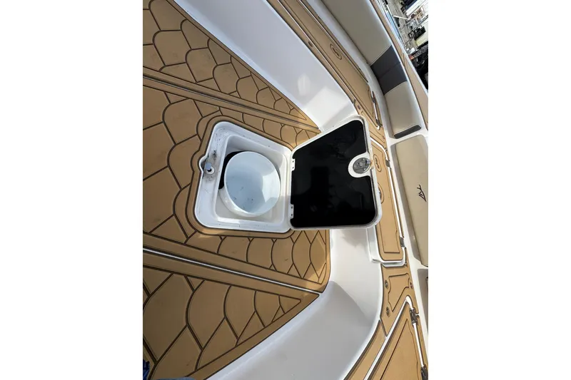 Slide: The Image of 2022 Tidewater 2300 Carolina Bay boat interior with open storage compartment. - 27