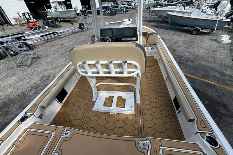Slide: The Image of 2022 Tidewater 2300 Carolina Bay boat interior with tan deck and seating. - 7