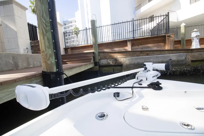Slide: The Image of 2014 Yellowfin 24 Bay boat with trolling motor docked near wooden pier. - 11