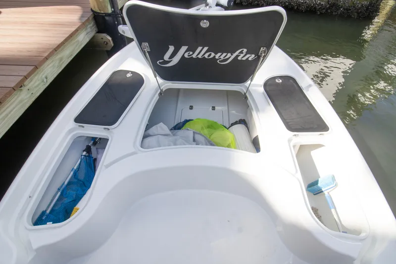 Slide: The Image of 2014 Yellowfin 24 Bay boat storage compartments open at dockside. - 12