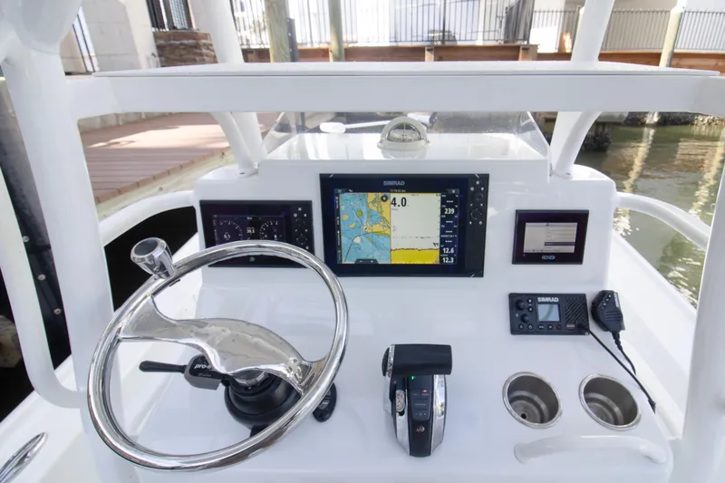 Slide: The Image of 2014 Yellowfin 24 Bay boat dashboard with steering wheel and navigation system. - 13