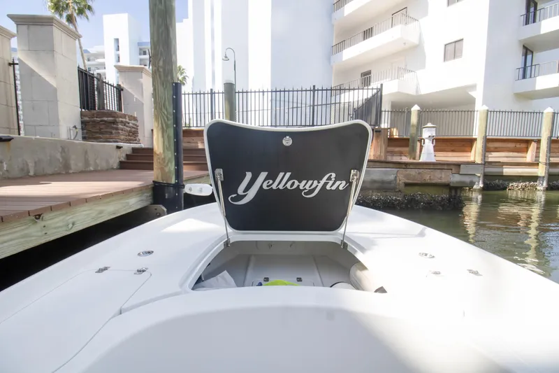 Slide: The Image of 2014 Yellowfin 24 Bay boat docked near waterfront buildings. - 16