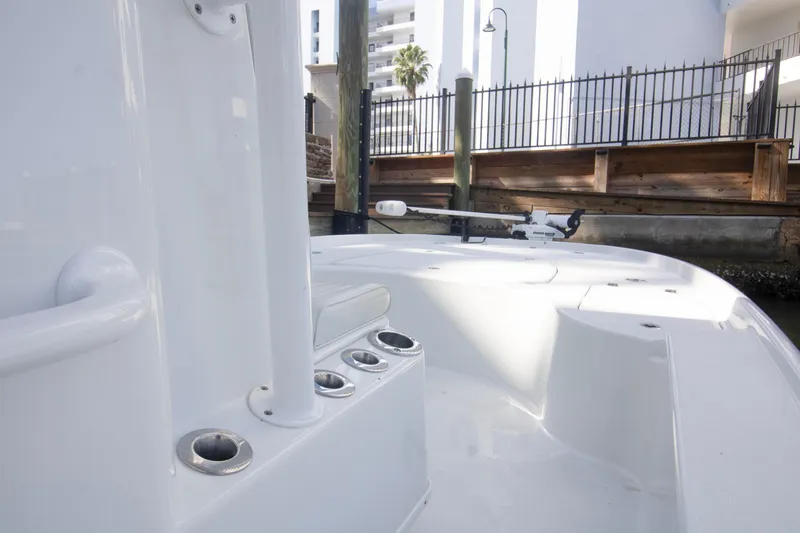 Slide: The Image of 2014 Yellowfin 24 Bay boat interior with rod holders and trolling motor. - 17