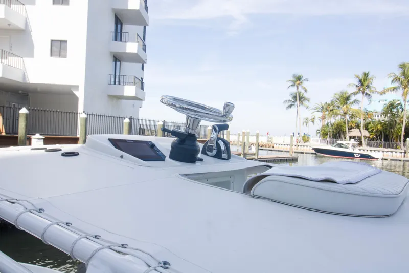 Slide: The Image of 2014 Yellowfin 24 Bay boat docked near palm trees and buildings. - 18