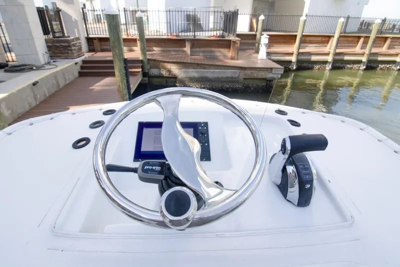 Slide: The Image of 2014 Yellowfin 24 Bay boat helm with steering wheel and controls. - 19