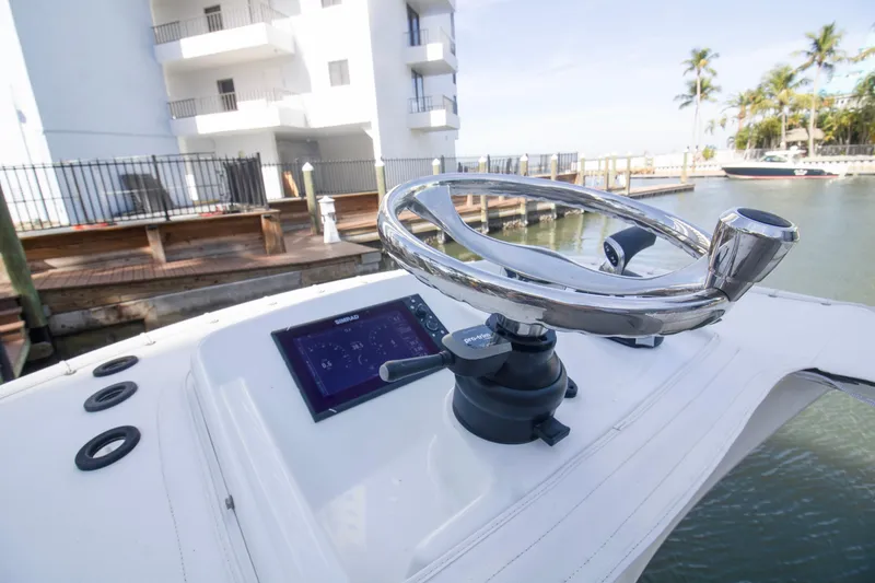 Slide: The Image of 2014 Yellowfin 24 Bay boat helm with steering wheel and navigation display. - 20