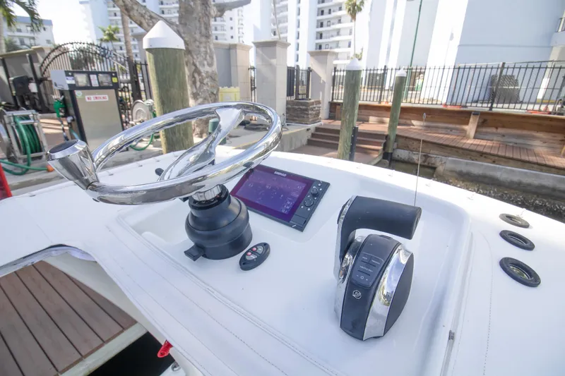 Slide: The Image of 2014 Yellowfin 24 Bay boat helm with steering wheel and control panel. - 21