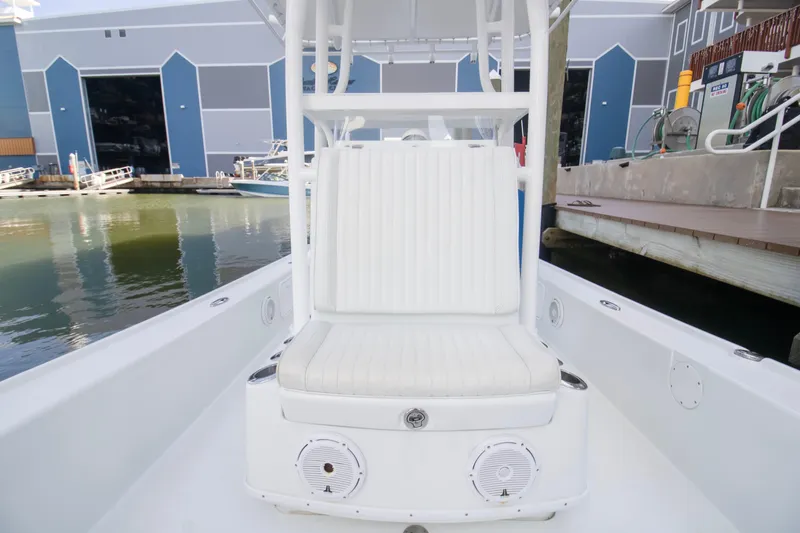 Slide: The Image of 2014 Yellowfin 24 Bay boat interior with white seating and speakers. - 9