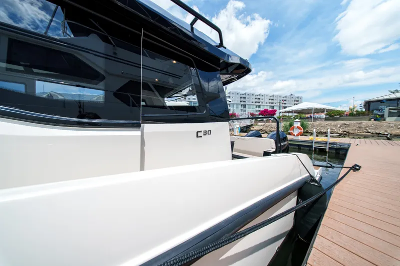Slide: The Image of 2026 Navan C30 yacht docked at marina under blue sky. - 10