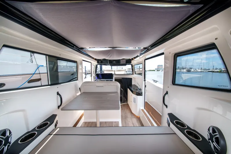 Slide: The Image of Interior of 2026 Navan C30 boat with modern seating and table, docked at marina. - 18