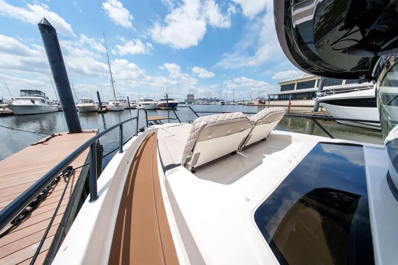 Slide: The Image of 2026 Navan C30 boat docked at marina, featuring luxurious seating and sleek design. - 21