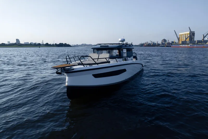 Slide: The Image of 2026 Navan C30 boat on water near industrial port. - 40