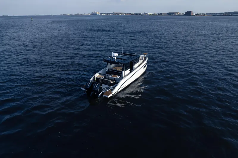 Slide: The Image of 2026 Navan C30 boat cruising on open water under clear skies. - 42