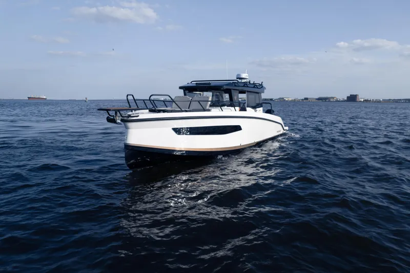 Slide: The Image of 2026 Navan C30 boat cruising on open water under a clear sky. - 44