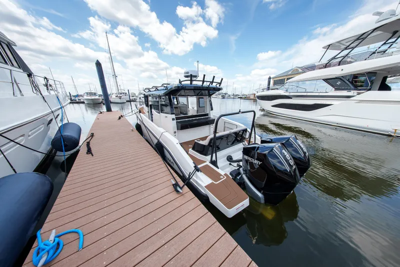 Slide: The Image of Modern 2026 Navan C30 boat docked at marina, featuring dual Mercury engines. - 7