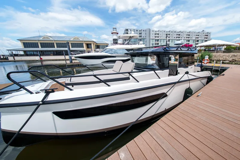 Slide: The Image of 2026 Navan C30 boat docked at marina, modern design, clear sky background. - 9