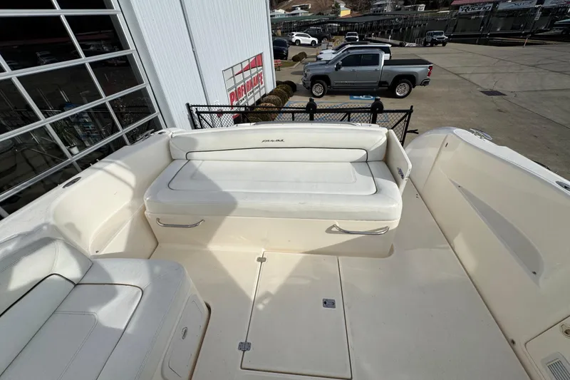 Slide: The Image of 2003 Riviera Cruiser M470 Excalibur boat interior with white seating and storage compartments. - 10