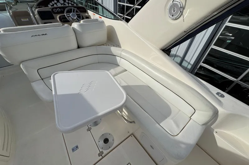 Slide: The Image of 2003 Riviera Cruiser M470 Excalibur interior with white seating and table. - 11