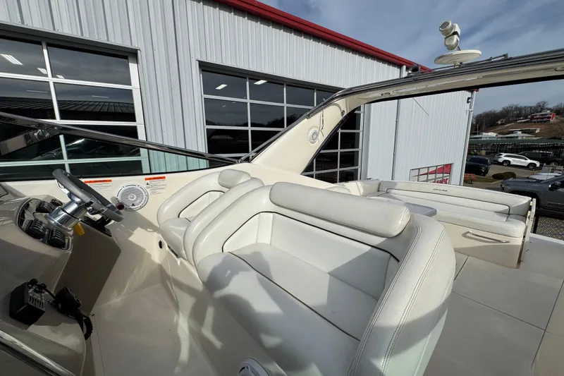 Slide: The Image of 2003 Riviera Cruiser M470 Excalibur boat interior with white seating and steering wheel. - 19