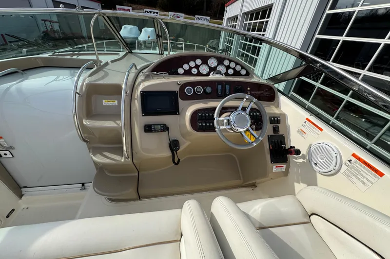 Slide: The Image of 2003 Riviera Cruiser M470 Excalibur boat dashboard with steering wheel and control panel. - 20