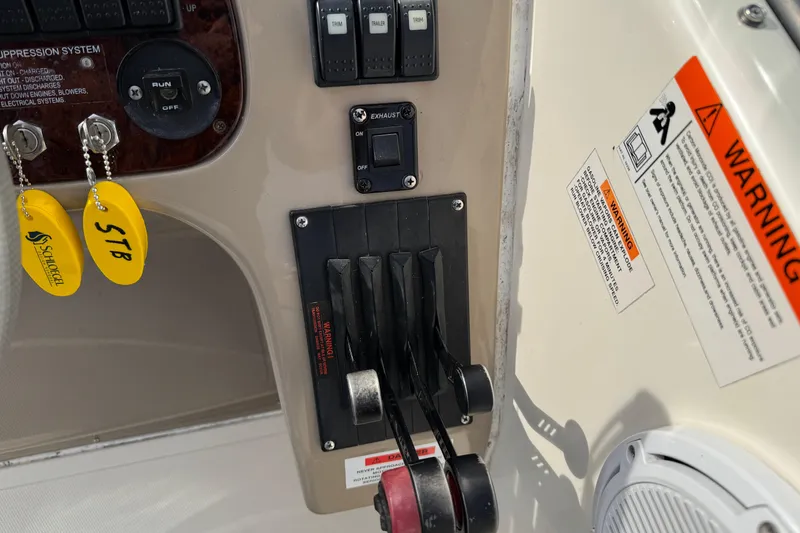 Slide: The Image of Control panel of a 2003 Riviera Cruiser M470 Excalibur with warning labels and keychains. - 25