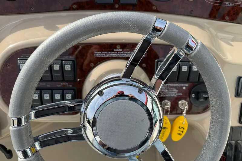 Slide: The Image of Steering wheel of a 2003 Riviera Cruiser M470 Excalibur boat dashboard. - 28