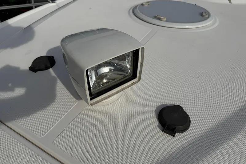 Slide: The Image of 2003 Riviera Cruiser M470 Excalibur spotlight on textured deck surface. - 32