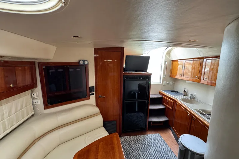Slide: The Image of Interior of 2003 Riviera Cruiser M470 Excalibur with kitchen and seating area. - 35