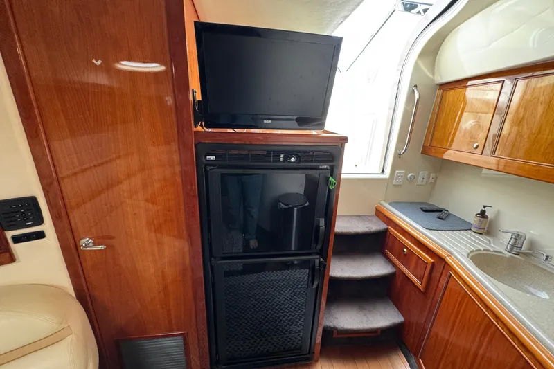 Slide: The Image of Interior of 2003 Riviera Cruiser M470 Excalibur with TV, fridge, and kitchenette. - 36
