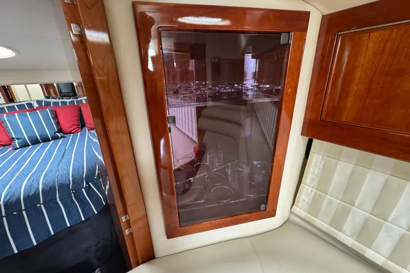 Slide: The Image of Interior of 2003 Riviera Cruiser M470 Excalibur with wood cabinetry and striped bedding. - 39