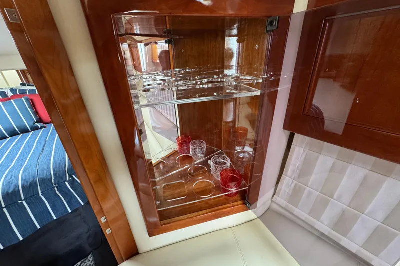 Slide: The Image of Luxurious interior of 2003 Riviera Cruiser M470 Excalibur with glassware cabinet. - 40