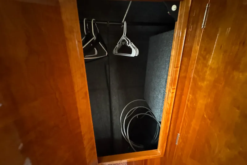 Slide: The Image of Wooden closet interior with hangers and cables, Riviera Cruiser M470 Excalibur 2003. - 44