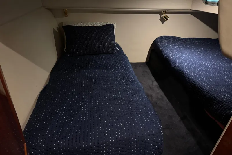 Slide: The Image of 2003 Riviera Cruiser M470 Excalibur cabin with twin beds and navy bedding. - 48