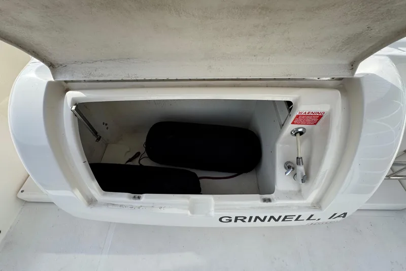 Slide: The Image of Open storage compartment on a 2003 Riviera Cruiser M470 Excalibur boat. - 7