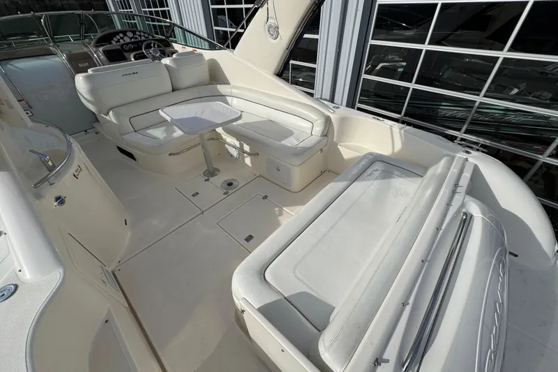 Slide: The Image of 2003 Riviera Cruiser M470 Excalibur boat interior with white seating and table. - 8