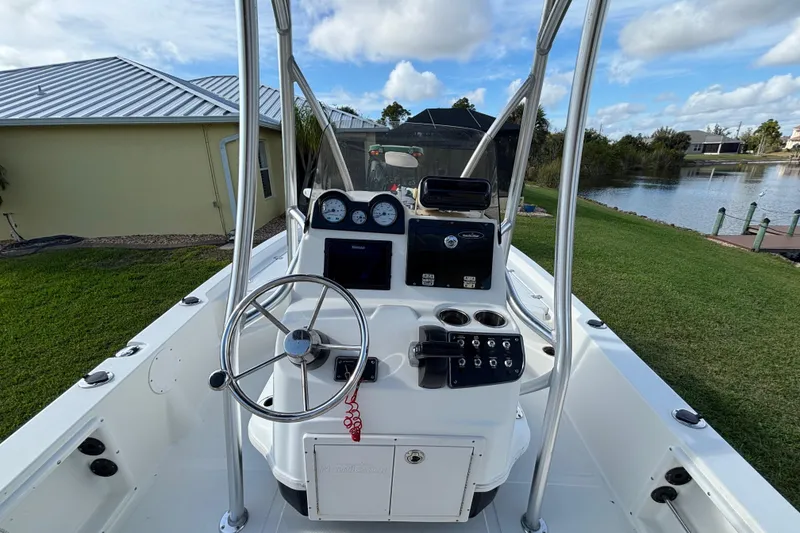 Slide: The Image of 2017 NauticStar 215 XTS Shallow Bay boat interior with steering console and gauges. - 10