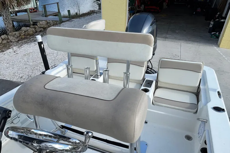 Slide: The Image of 2017 NauticStar 215 XTS Shallow Bay boat interior with seating and steering wheel. - 11