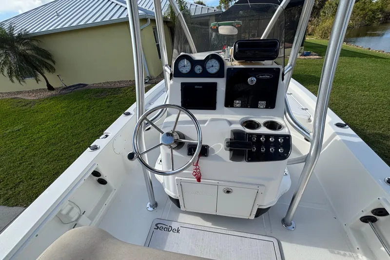 Slide: The Image of 2017 NauticStar 215 XTS Shallow Bay boat interior with steering console and controls. - 13