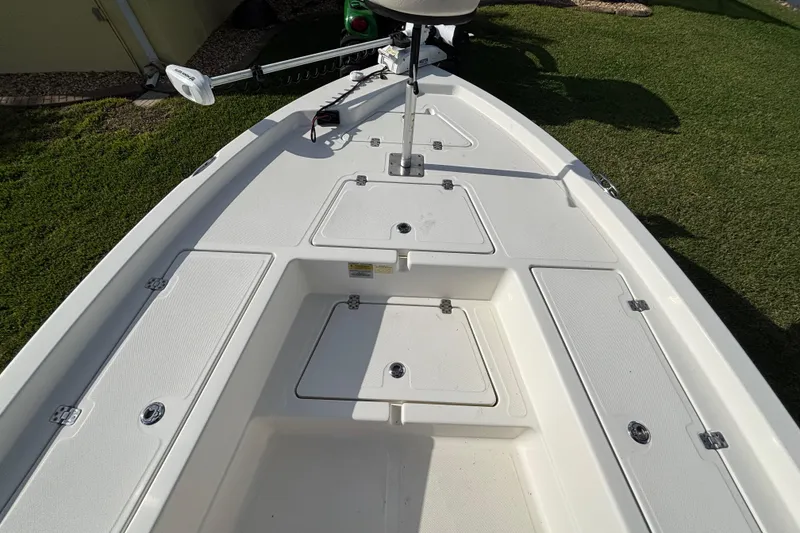 Slide: The Image of 2017 NauticStar 215 XTS Shallow Bay boat deck with storage compartments. - 17