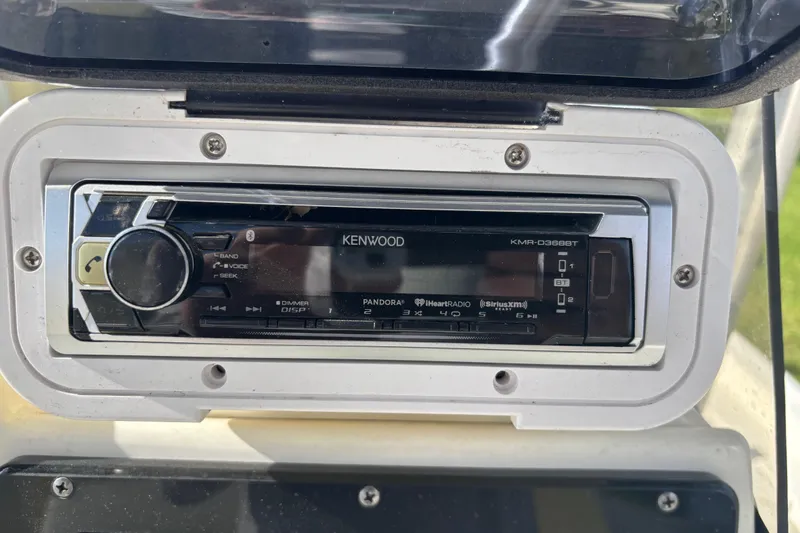 Slide: The Image of Kenwood stereo system on 2017 NauticStar 215 XTS Shallow Bay boat dashboard. - 19