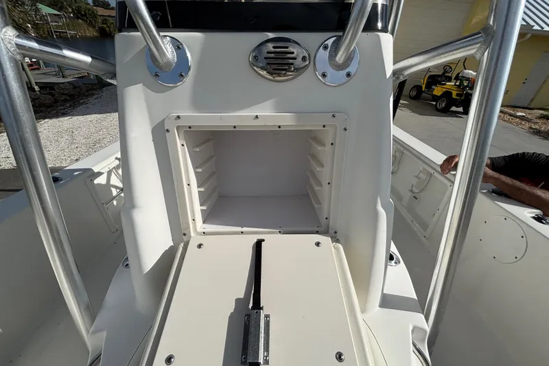 Slide: The Image of 2017 NauticStar 215 XTS Shallow Bay boat console with open storage compartment. - 20