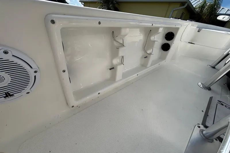 Slide: The Image of 2017 NauticStar 215 XTS Shallow Bay boat interior with speaker and storage compartment. - 23