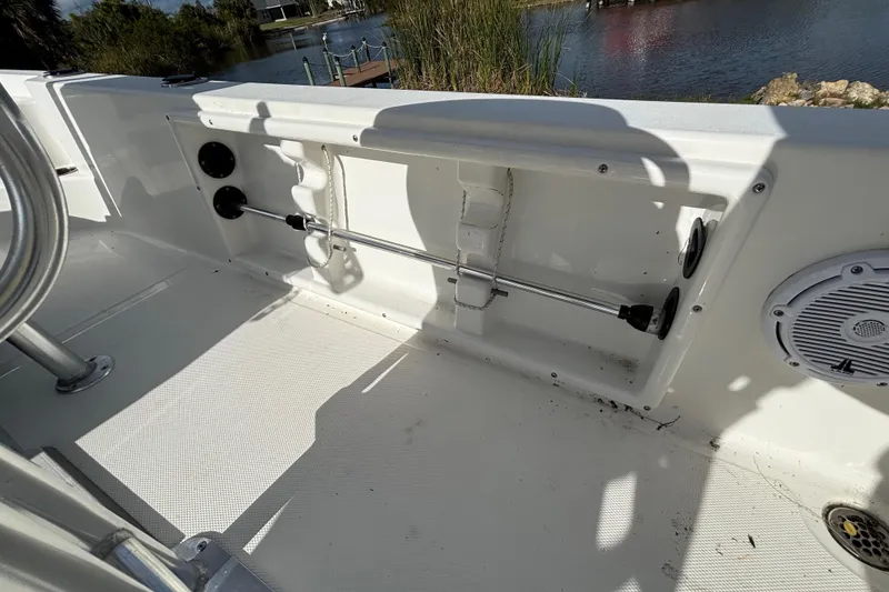 Slide: The Image of 2017 NauticStar 215 XTS Shallow Bay boat interior with rod holder and speaker. - 24