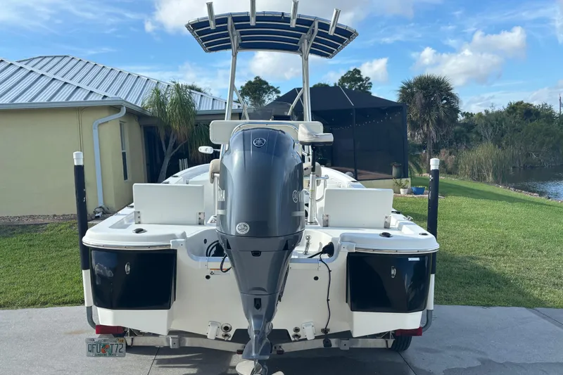 Slide: The Image of 2017 NauticStar 215 XTS Shallow Bay boat with Yamaha outboard motor, parked near a lake. - 7